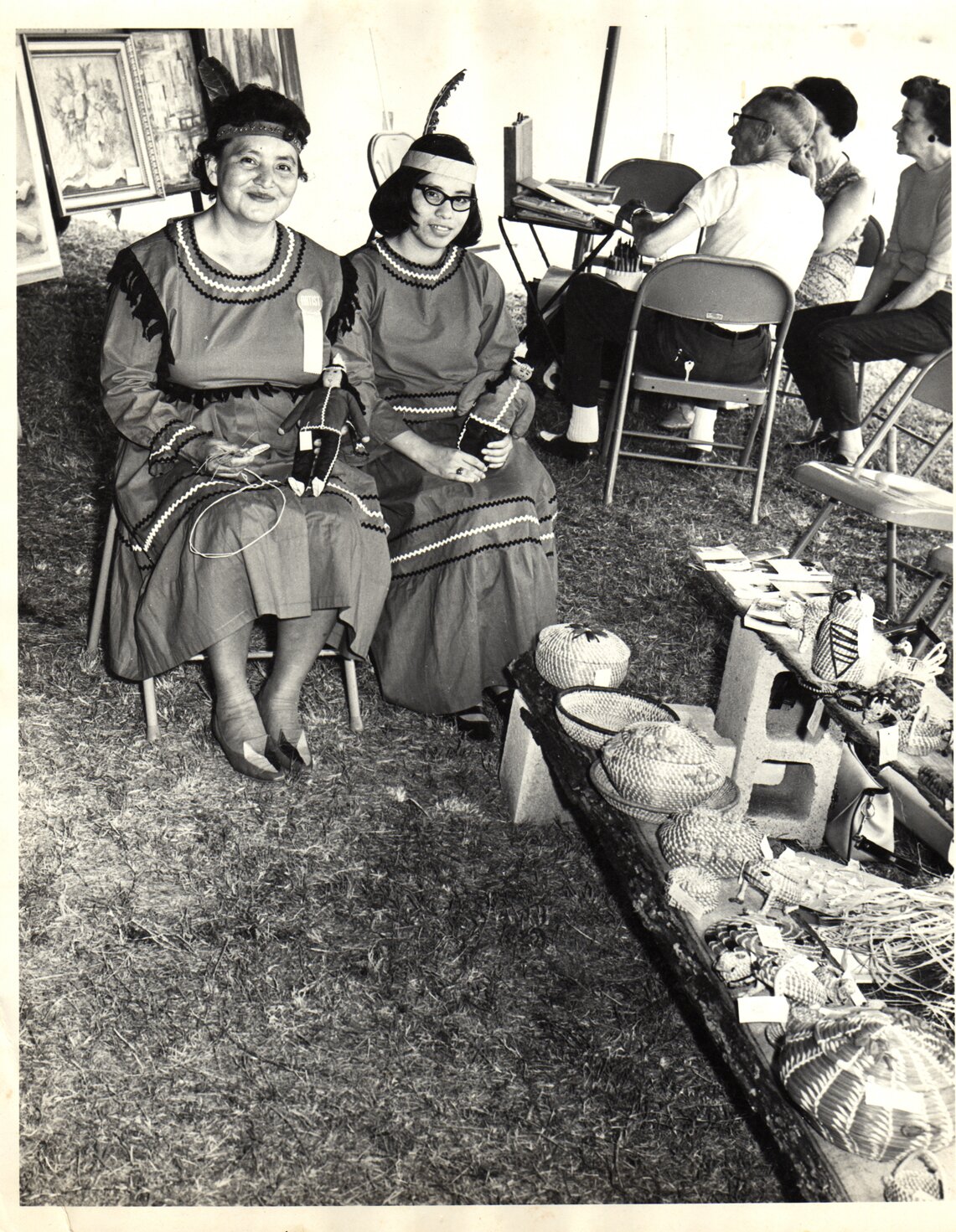 Ruth and Adrienne Poncho selling baskets